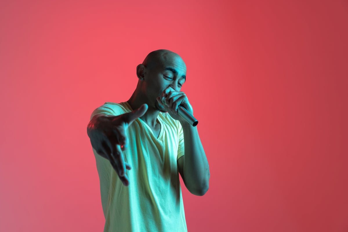 GroovyD, Neon Beams artist and songwriter, rapping under neon light
